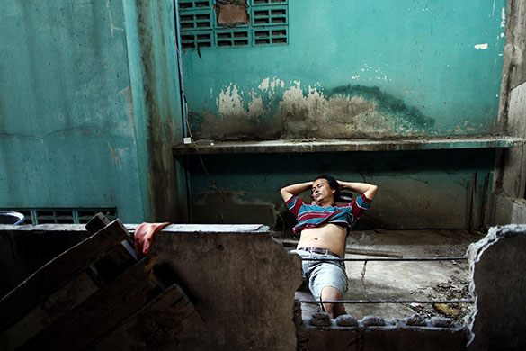 24 hours in pictures: Mahachai, Thailand: A migrant worker from Myanmar