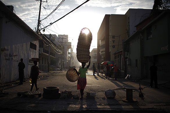 24 hours in pictures: Port-au-Prince, Haiti: A woman carries baskets