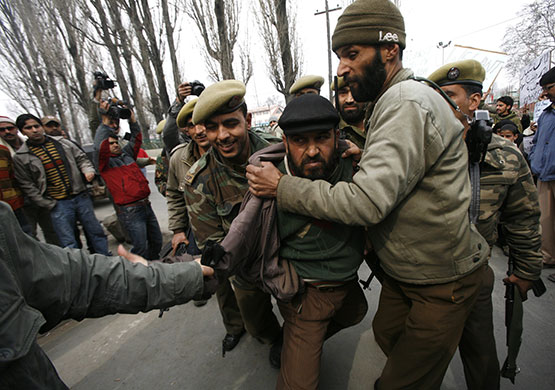 24 hours in pictures: Srinagar, India: Policemen detain a Kashmiri Muslim protester