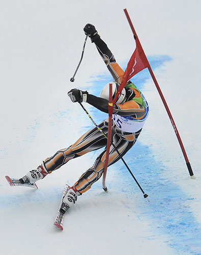 Winter Olympics Day 12: Chile's Jorge Mandru crashes into a gate during the Men's giant slalom