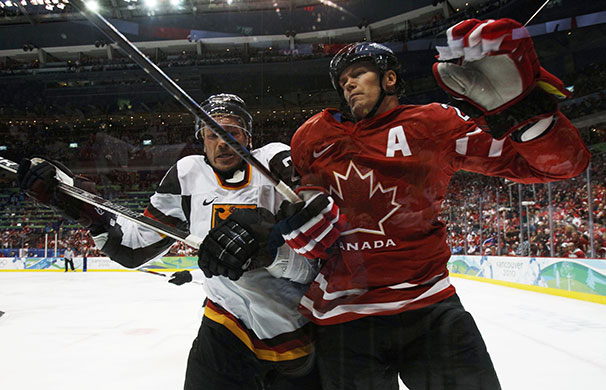 Winter Olympics Day 12: Germany's John Tripp collides with Canada's Chris Pronger 