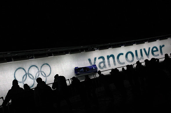 Winter Olympics Day 12: Great Britain's Nicola Minichello and Gillian Cooke speed past spectators