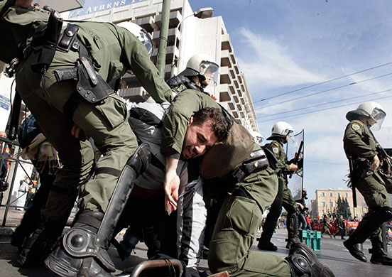 clashes in greece: Police arrest a demonstrator in Athens