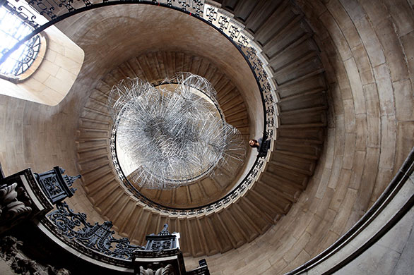 24 hours in pictures: London, UK: A woman admires an artwork entitled Flare II by Antony Gormley