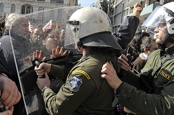 24 hours in pictures: Athens, Greece: Police pushe demonstrators during a protest march