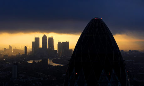 The sun rises over the City of London.