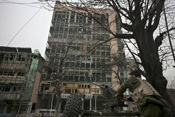 Kabul explosions: An Afghan soldier trains his grenade launcher towards a hotel 
