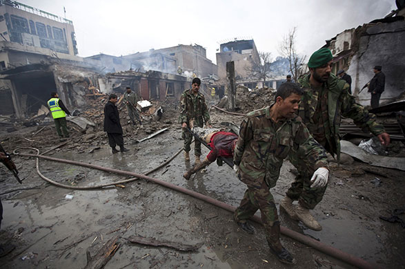 Kabul explosions: Afghan National Army soldiers carry a victim from the site of a blast