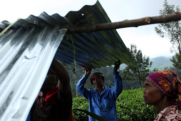 24 hours: Dewata, Indonesia: Villagers make a temporary house after a landslide