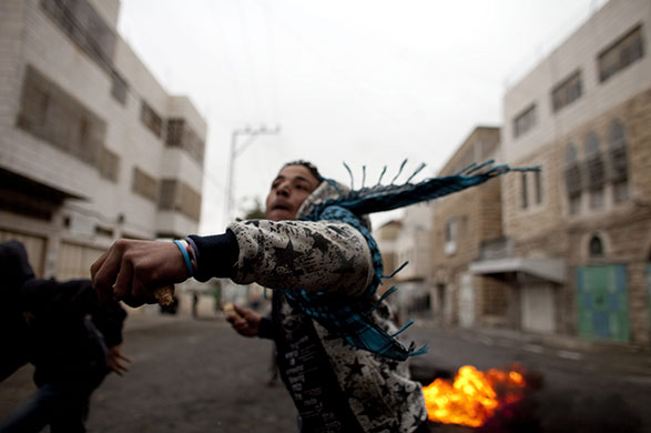 24 hours: Hebron, West Bank: Palestinian youths throw rocks during clashes 