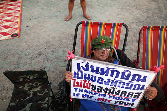 24 hours: Bangkok, Thailand: A supporter of former Thai PM Thaksin Shinawatra