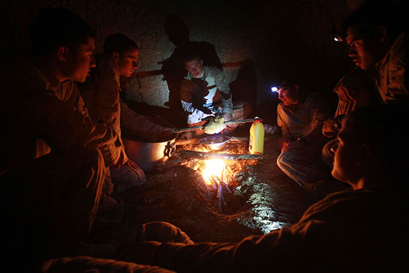 24 hours: Marjah, Afghanistan: US Marines cook a chicken
