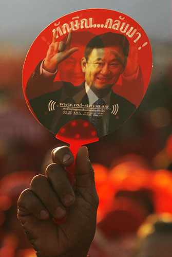 Thaksin Shinawatra: 28 March 2009: A demonstrator holds a fan