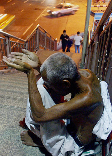 Thaksin Shinawatra: 17 November 2003: A beggar near a train station in Bangkok