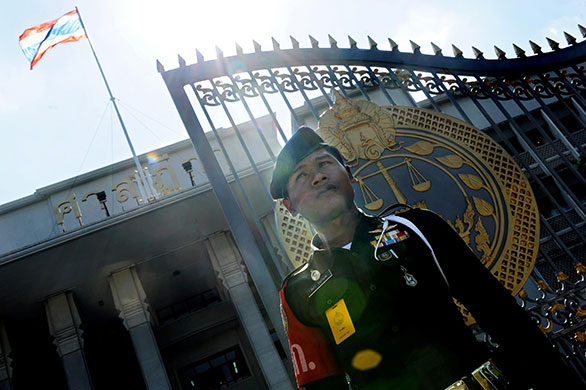 Thaksin Shinawatra: 25 February 2010: A policeman stands guard outside the Supreme Court