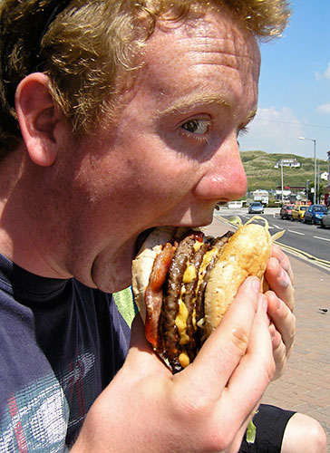 In Pictures: greed: man eating burger