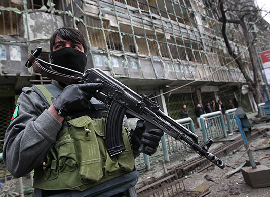 Kabul explosions: An Afghan commando stands guard outside the the Park Residence guesthouse