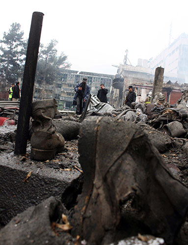 Kabul explosions: Afghan security officials inspect the scene of a suicide bomb attack 