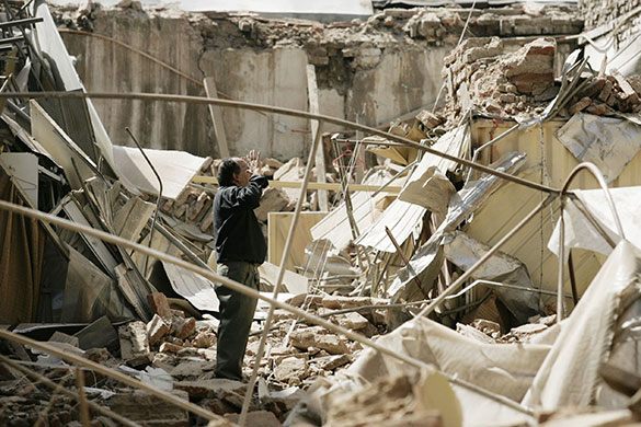 Chile Earthquake: A man stands amidst the rubble after earthquake in Santiago, Chile