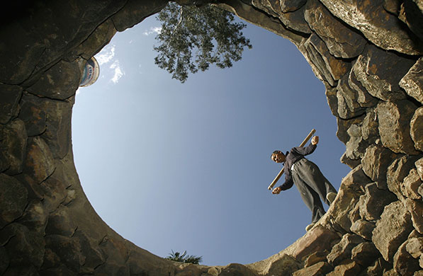 24 hours in pictures: A villager stands at the edge of a partially dried-up well, China