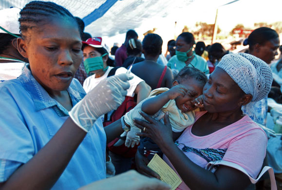 Haiti: 2 February: A baby cries after she was vaccinated against multiple diseases