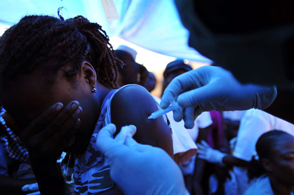 Haiti: 2 February: A girl receives a vaccine at the National Stadium