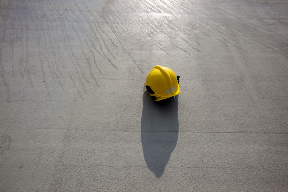 London's Air Ambulance: A fireman's hat lays on the ground as fire crews hose down the helipad