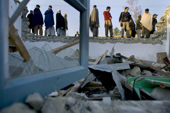 Eyewitness: Shahi Koto, Pakistan: Local residents examine a school damaged by a bomb