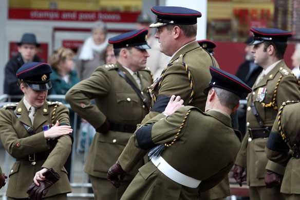 Eyewitness: Truro, UK: Mourners adjust their black armbands as they at a funeral
