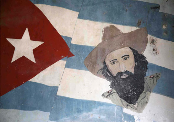 Cuban Stories: A painting of Camilo Cienfuegos on a flag, Havana