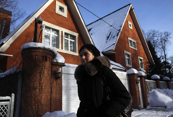 Sokol Village Moscow: People walk past a new, illegally-built house at the Sokol Village
