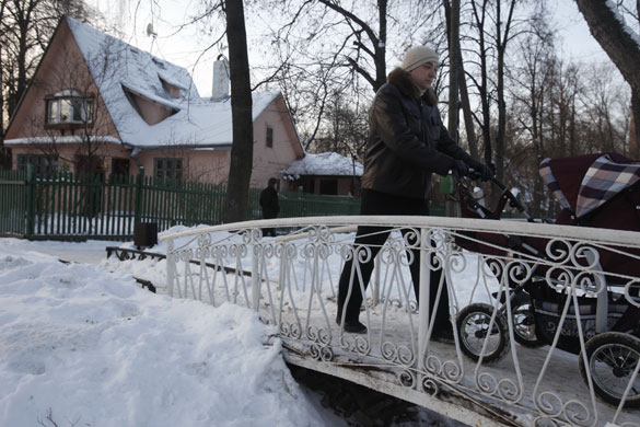 Sokol Village Moscow: People walk past an old house at the Sokol Villag