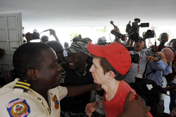 Haiti child trafficking: A Haitian policeman with Silas Thompson, 19, of Twin Falls, Idaho