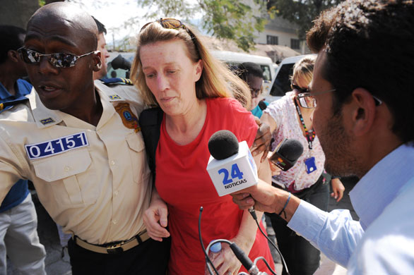 Haiti child trafficking: Corinna Lankford from Meridian, Idaho is escorted into a building