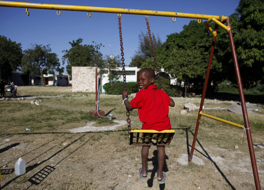 Haiti child trafficking: Abdias, 8, on a swing inside 