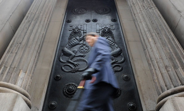 Business week in pictures: A man passes a doorway at the Bank of England 