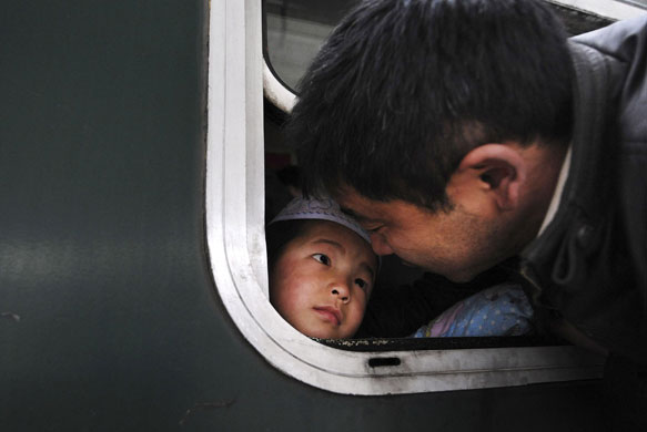 24 hours: A father sees his seven-year-old son off at a railway station in Hefei