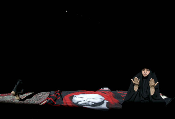 24 hours: Najaf, Iraq: A woman prays during her son's funeral 