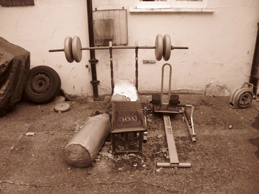 Readers' pics: exercise: Sepia photo of a neglected workout bench in a garden