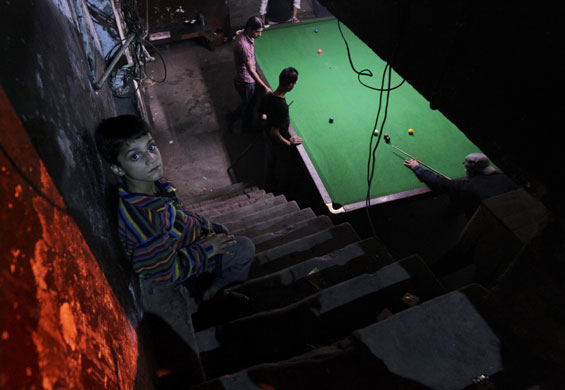 24 Hours in Pictures: Pakistani men play snooker in a club in Lahore