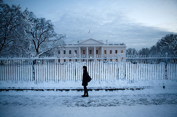 Washington in the snow: A woman walks on Pennsylvania Avenue, in front of the White House
