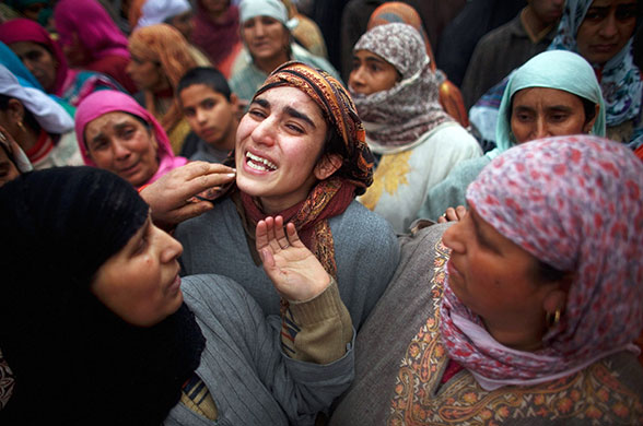 7 February 2010: Srinagar, India: A girl is consoled by relatives and friends