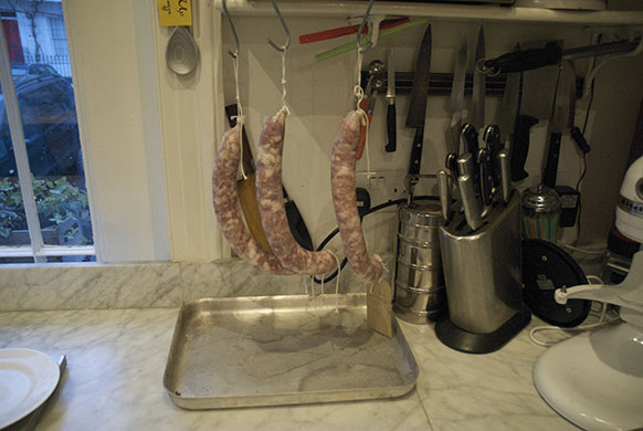 Making salami: 14. Hang inside for a couple of days while the skins tighten