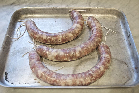 Making salami: 12. Twist the and cut your salamis and secure with string