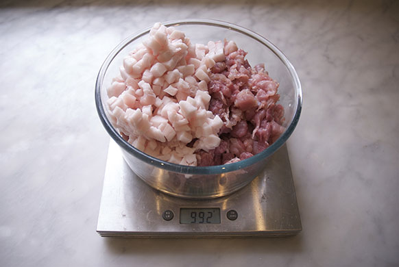 Making salami: 6. Combine the chopped shoulder meat with the cubed fat 