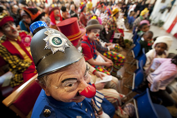 24 hours in pictures: London, UK: A clown wearing an policeman's hat 