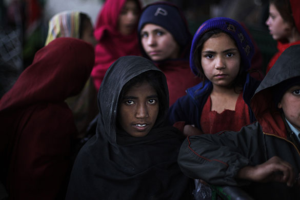 24 hours in pictures: Islamabad, Pakistan: Girls wait to get a ration of rice