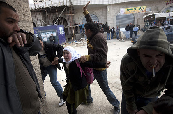 24 hours in pictures: Jerusalem: A Palestinian schoolgirl is evacuated during clashes