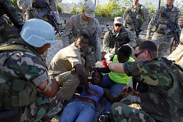 24 hours in pictures: Haiti: UN peacekeepers assist a woman with breathing problems