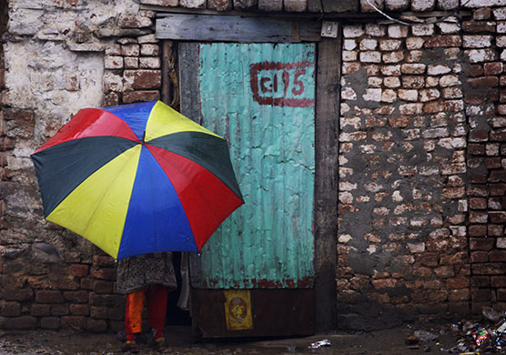 24 hours in pictures: Islamabad, Pakistan: A girl holding an umbrella